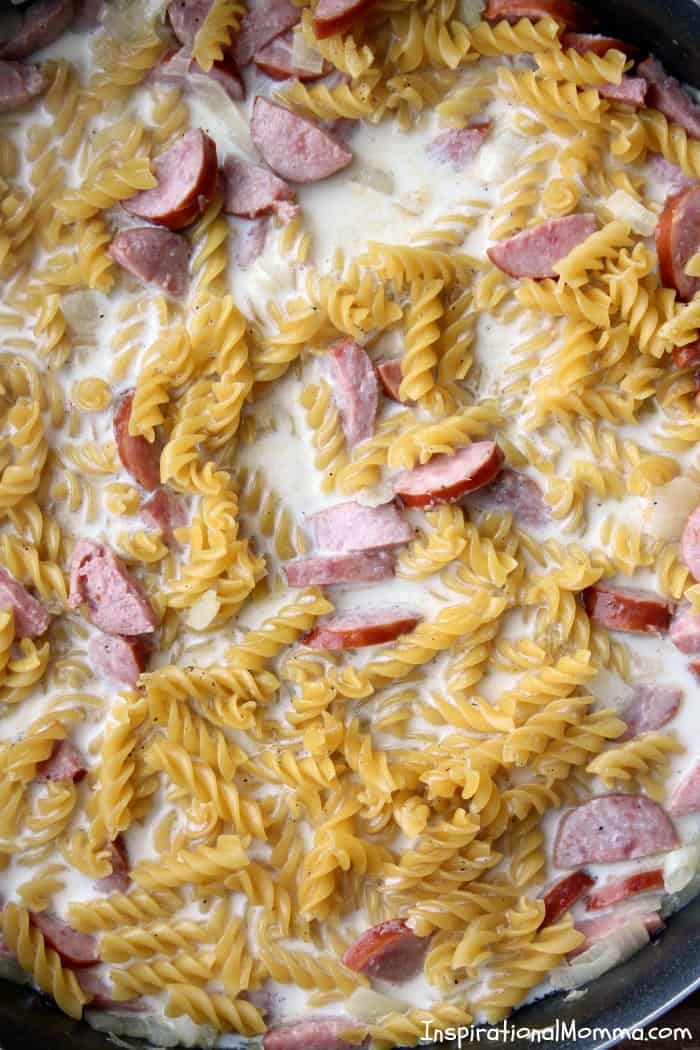 Ready in just 20 minutes, this One-Pan Cheesy Kielbasa Pasta will make everyone in your family smile! Simple and delicious! #inspirationalmomma #onepancheesykielbasapasta #onepan #kielbasa #cheesy #pasta #dinner #recipe