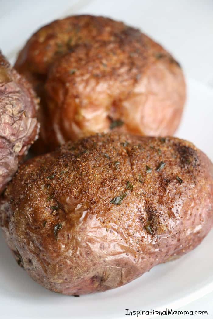 Easy Air Fryer Baked Potatoes are drizzled with olive oil and sensationally seasoned. Cooked to perfection in your Air Fryer, you will make them again and again! #InspirationalMomma #AirFryer #bakedpotatoes #potatoes #baked #quick #easy 