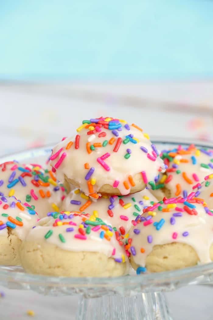 Soft Chewy Confetti Cookies are light, delicious and melt in your mouth. Covered with sweet icing and sprinkles, they are absolutely irresistible! #inspirationalmomma #confetticookies #cookies #softandchewy #recipe #dessert #desserts #cookie