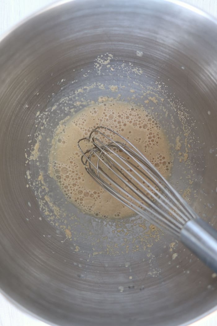 Preparing the yeast in a large metal bowl.