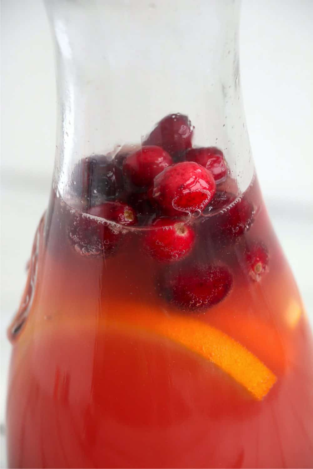 Punch ingredients in a glass pitcher.