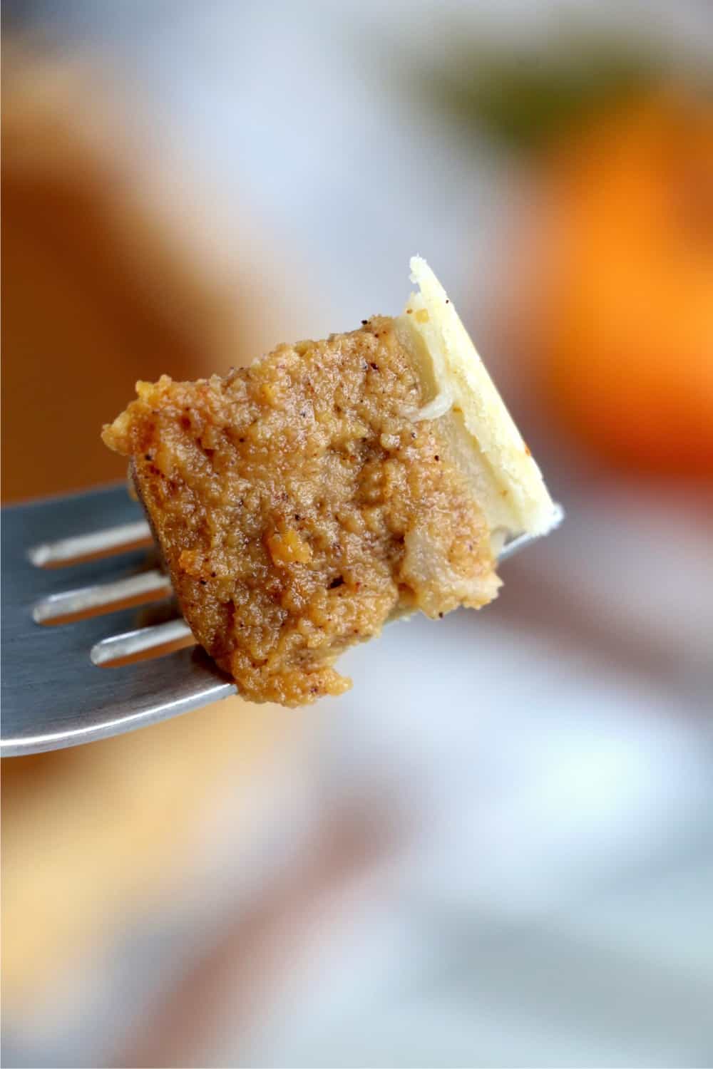 Piece of pumpkin pie on a fork.