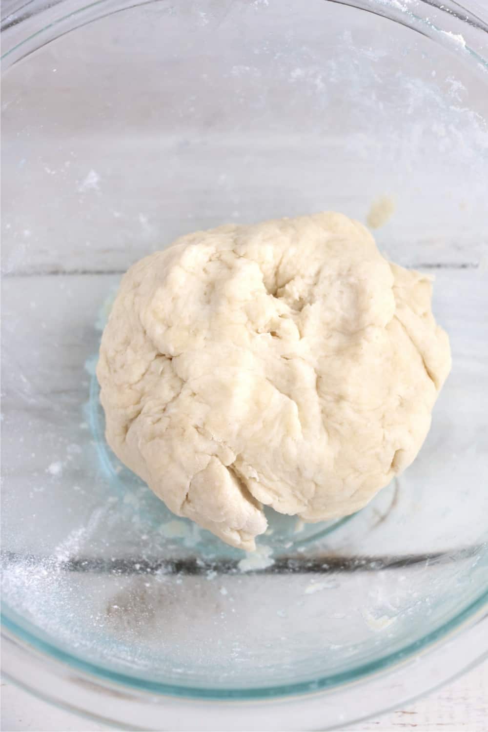 Pie crust mixed into a ball in a mixing bowl.