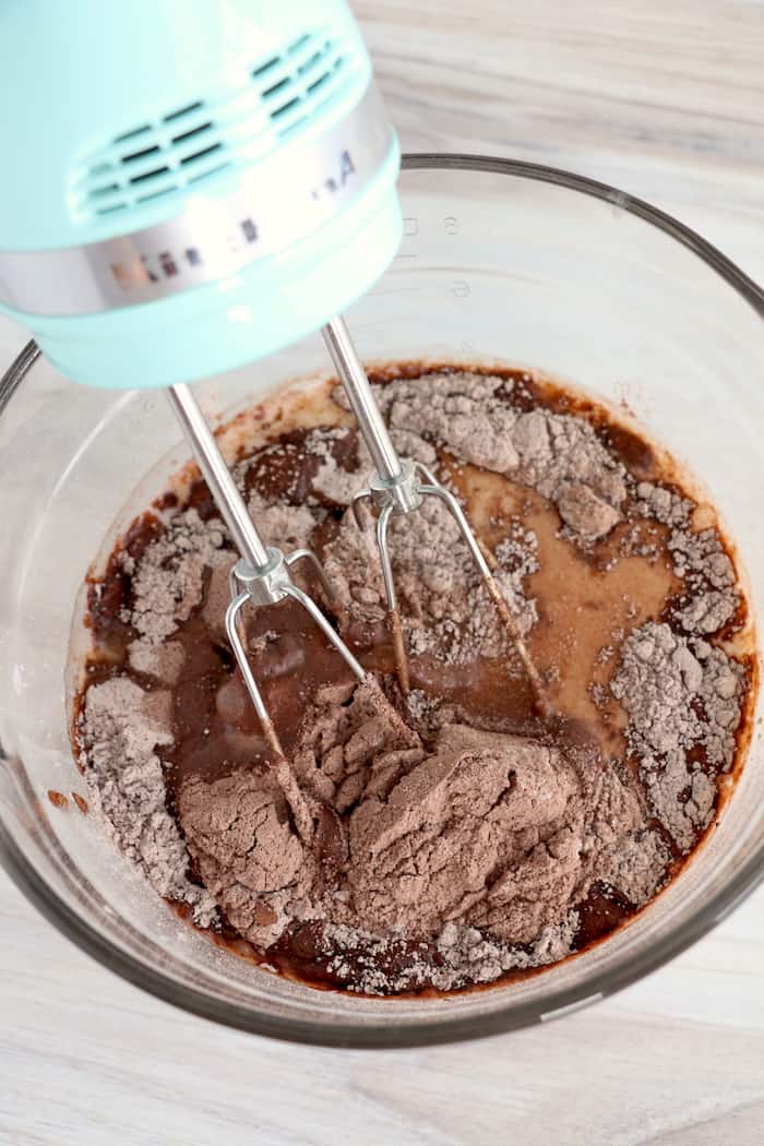 Ingredients for the chocolate layer in a clear glass bowl.