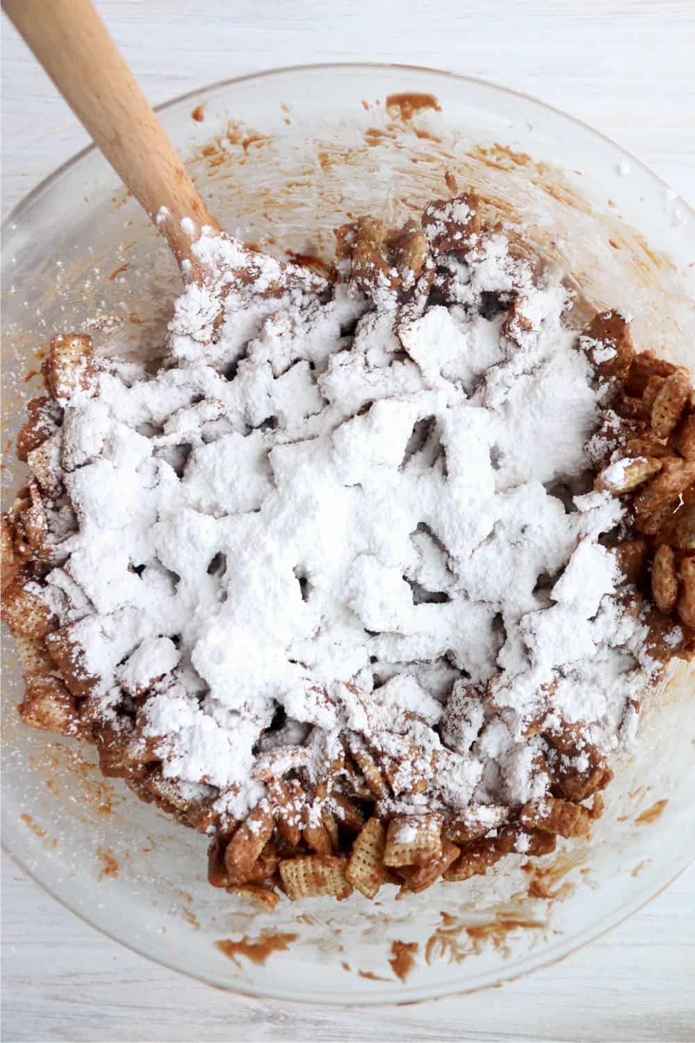 Sprinkle powdered sugar over top. Put the cover on again and toss until the cereal is coated in powdered sugar.