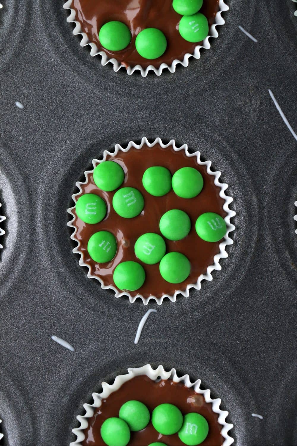 top the no bake Chocolate Pecan Clusters with green M&Ms, perfect for St. Patrick's Day
