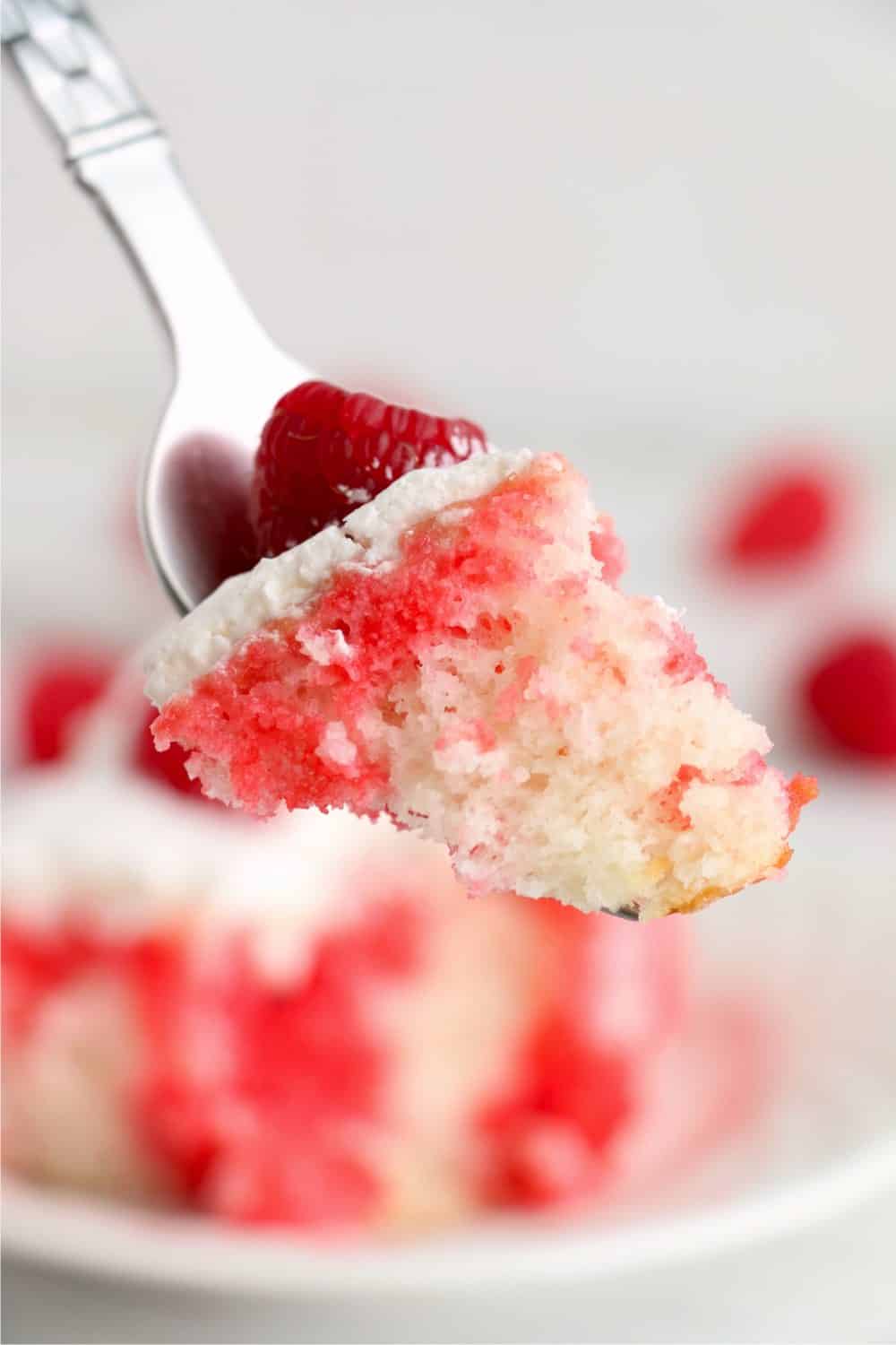 This Raspberry Poke Cake is made with a white cake mix, jello, and whipped topping. Easy to make, moist, and delicious!