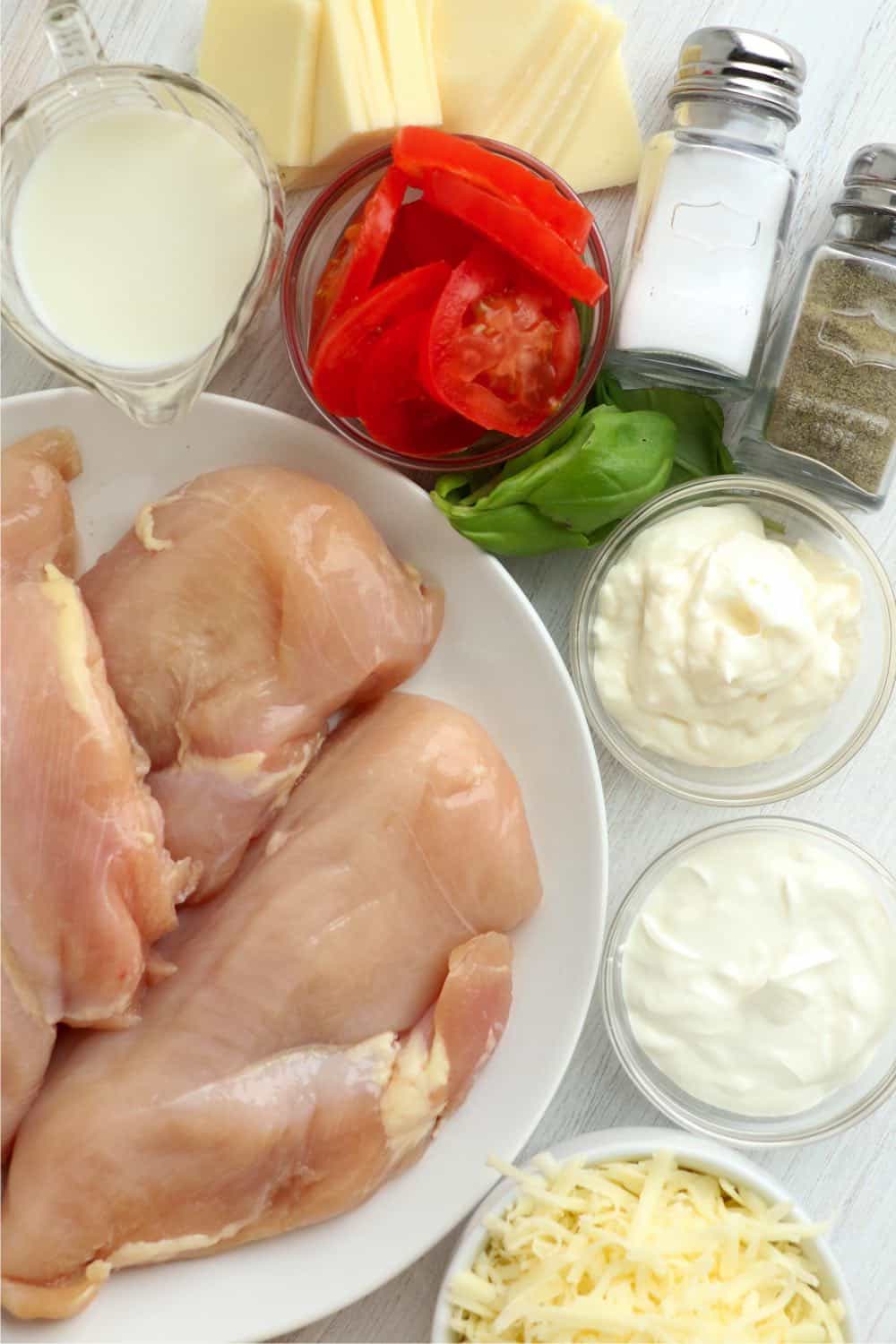 Chicken breasts, tomatoes, fresh basil, salt, pepper, mayonnaise, sour cream, mozzarella cheese