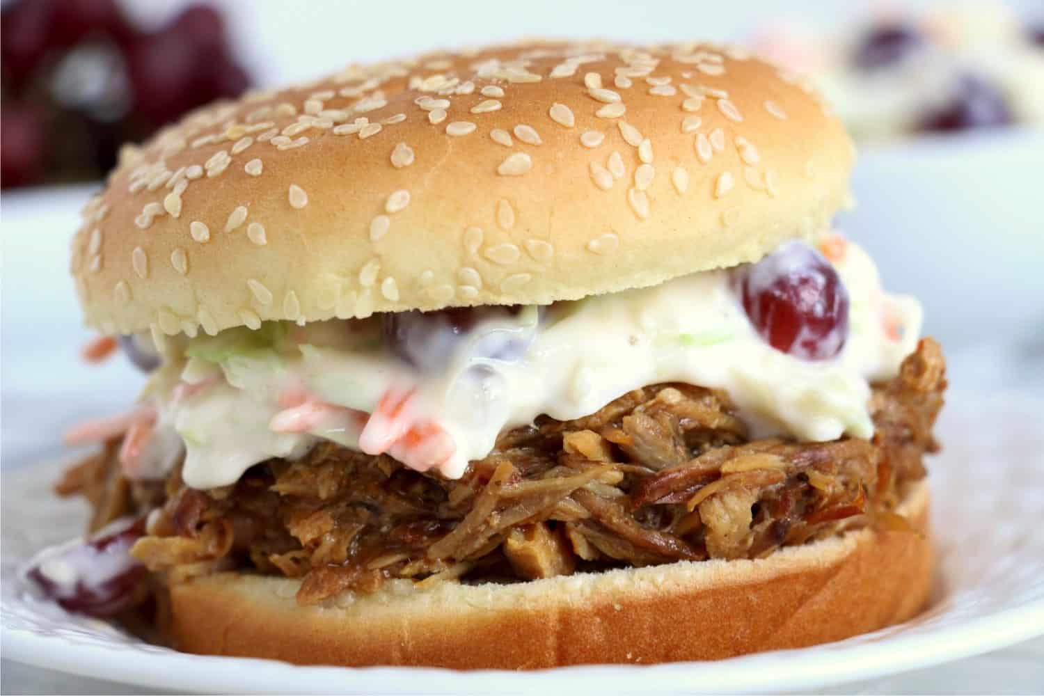 A close-up shot of a hamburger made with Crock Pot BBQ Pulled Pork and cole slaw