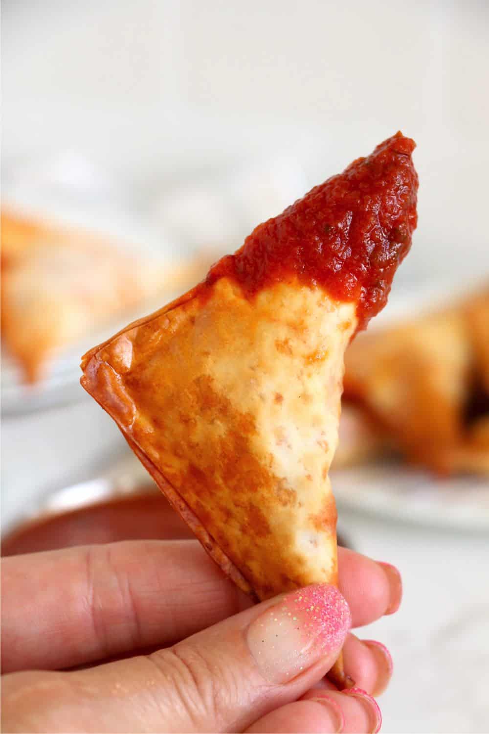 Air Fryer Pizza rolls that the top portion has been dipped into pizza sauce. 