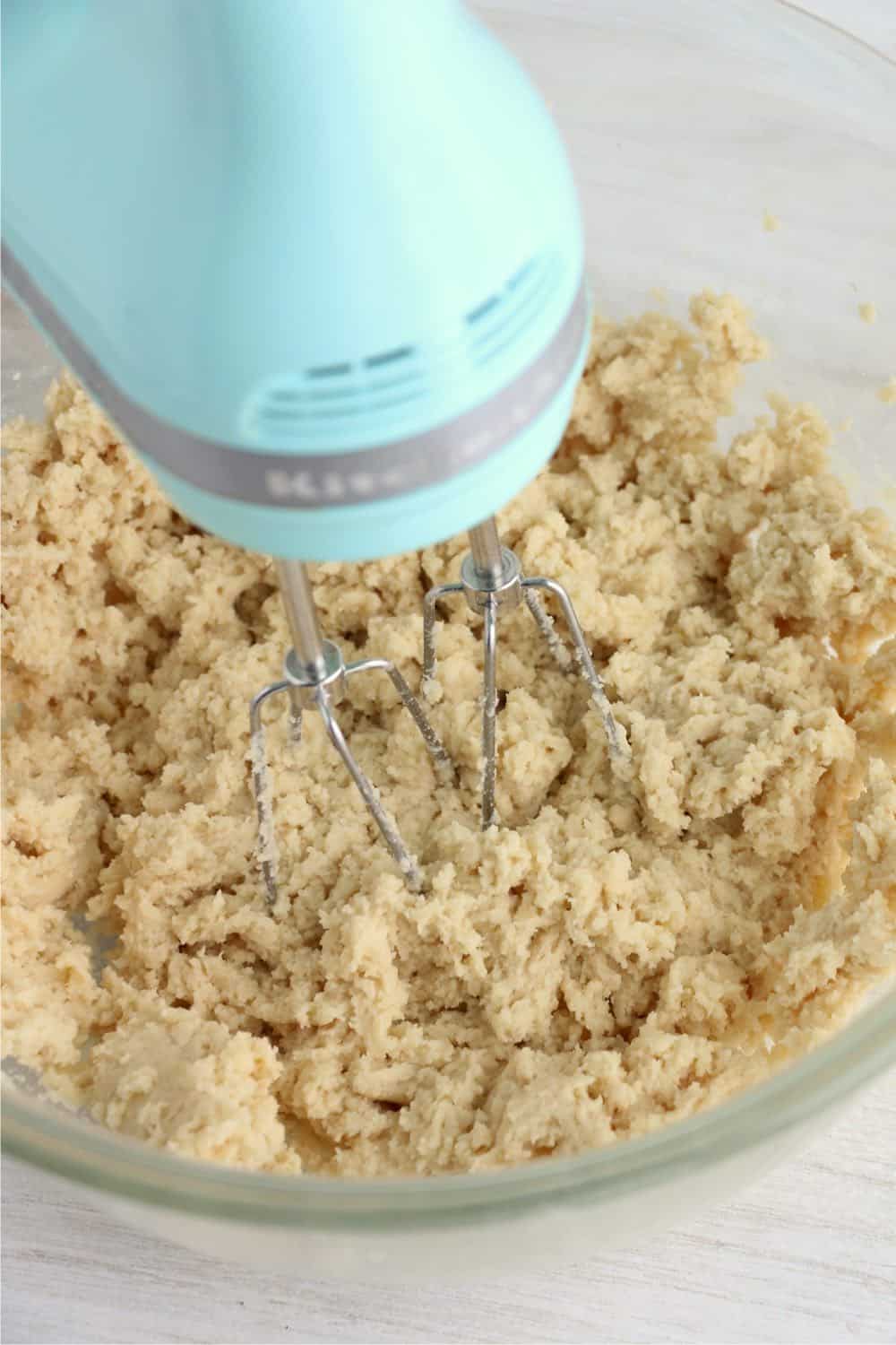 blue kitchen aid mixer mixing sugar cookie dough