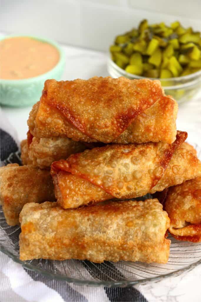 Stack of golden egg rolls on plate