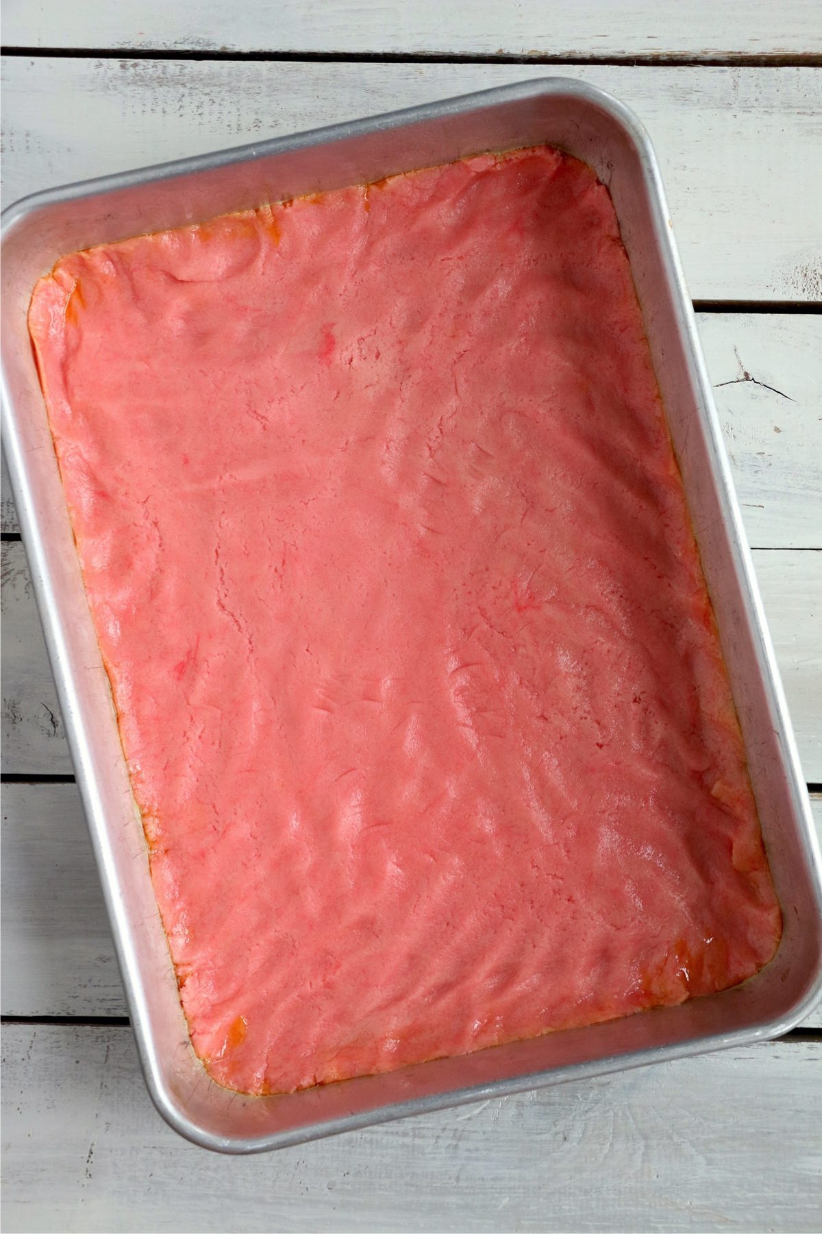 Overhead shot of pink cake mix in baking dish