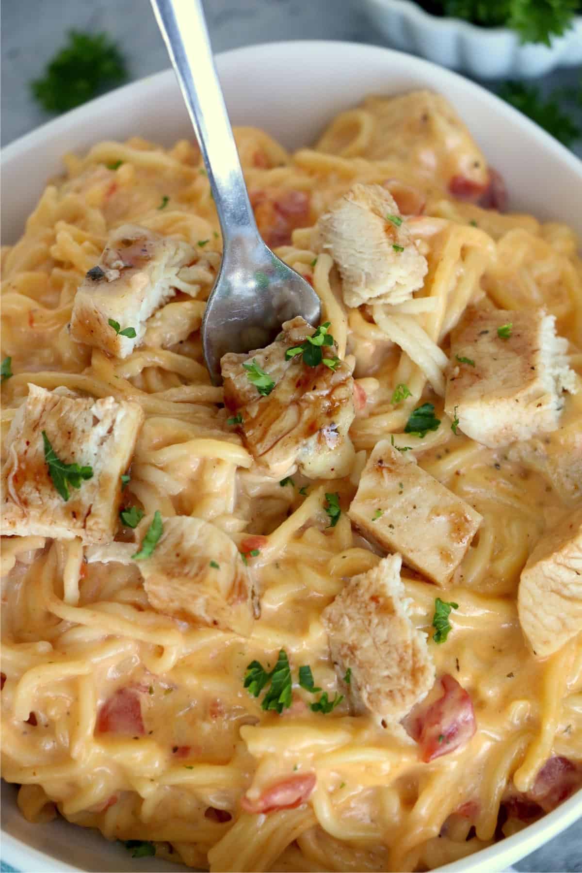 Closeup shot of fork stuck in bowl of pasta
