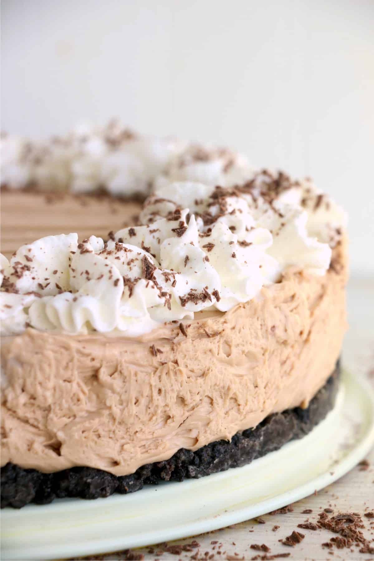 Closeup shot of Kahlua chocolate cheesecake decorated with whipped cream and shaved chocolate