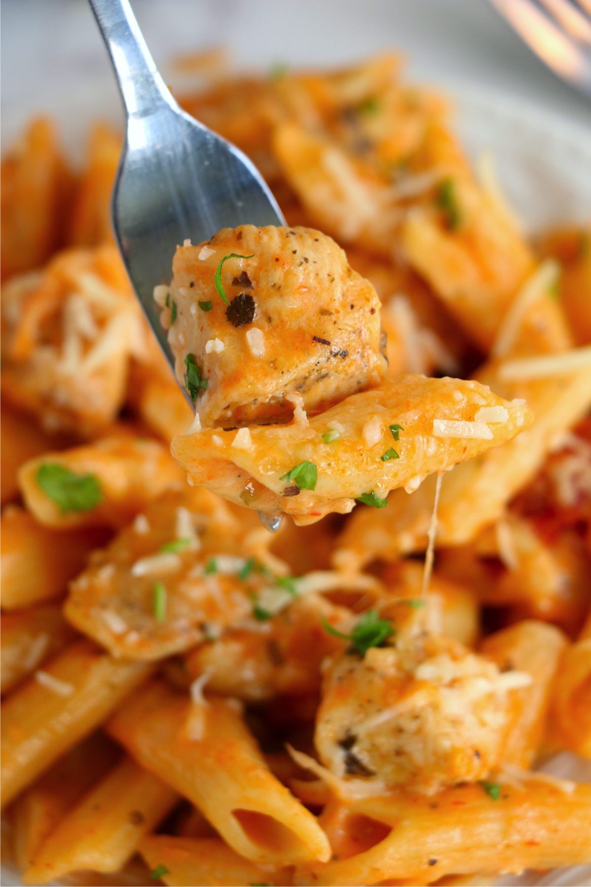 Closeup shot of forkful of Instant Pot chicken parmesan pasta