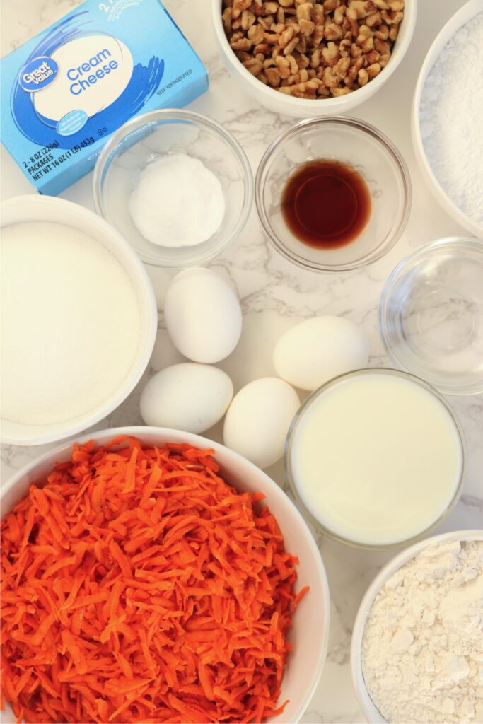 Overhead shot of carrot cake ingredients in individual bowls