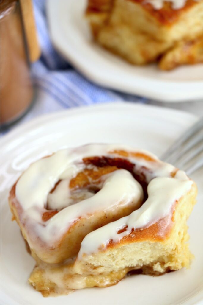 Closeup shot of iced cinnamon roll on plate