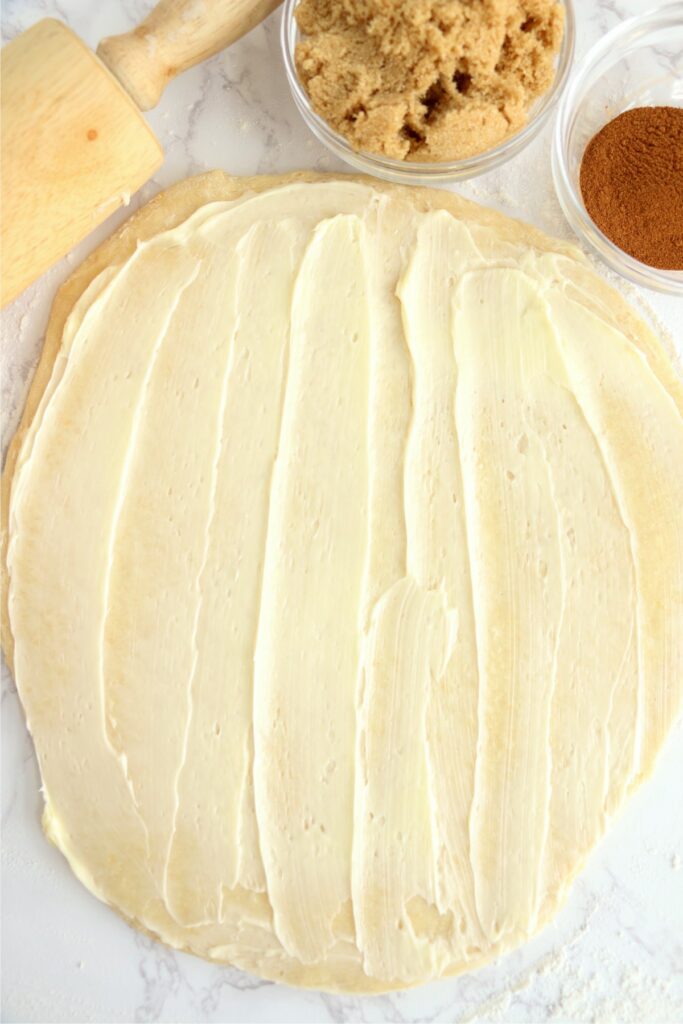 Overhead shot of dough spread with butter