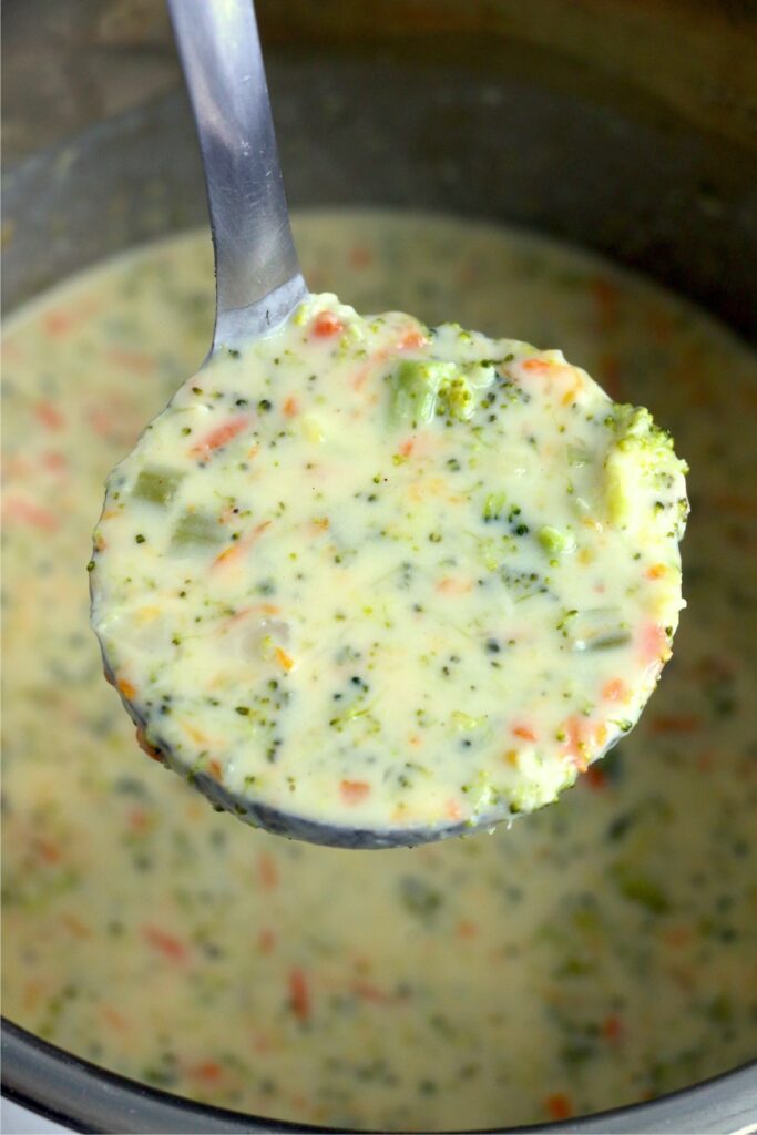 Closeup shot of ladle full of instant pot panera broccoli cheddar soup