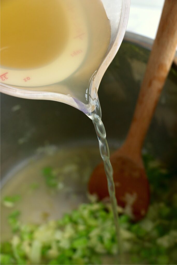 Chicken broth being poured into instant pot