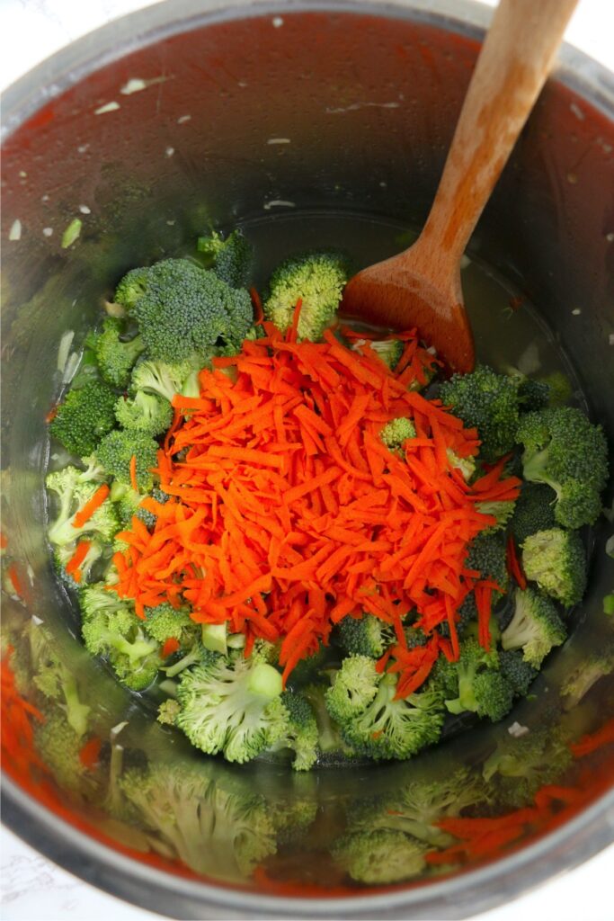 Broccoli and carrots in instant pot with broth and celery and oinions