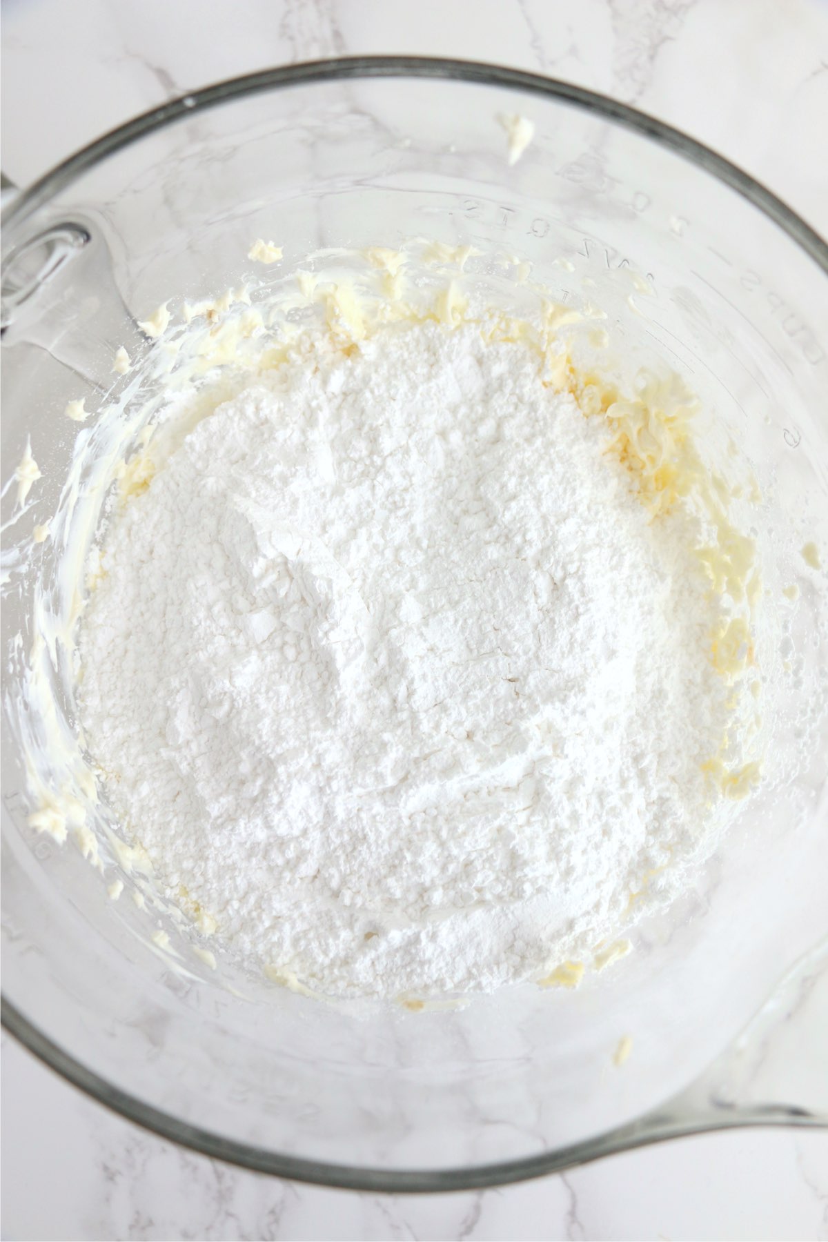 Overhead shot of cream cheese frosting  ingredients in bowl 