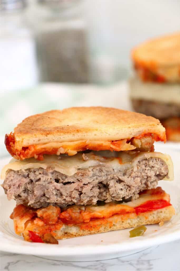 Closeup shot of frozen pizza burger cut in half on plate