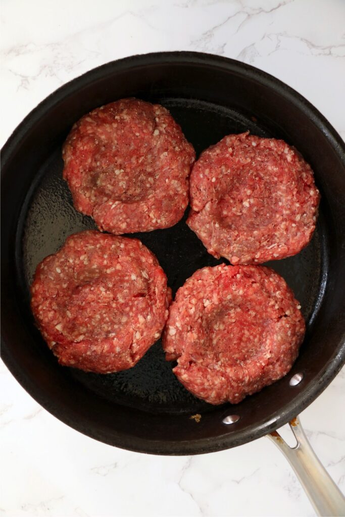 Overhead shot of hamburgers in skillet