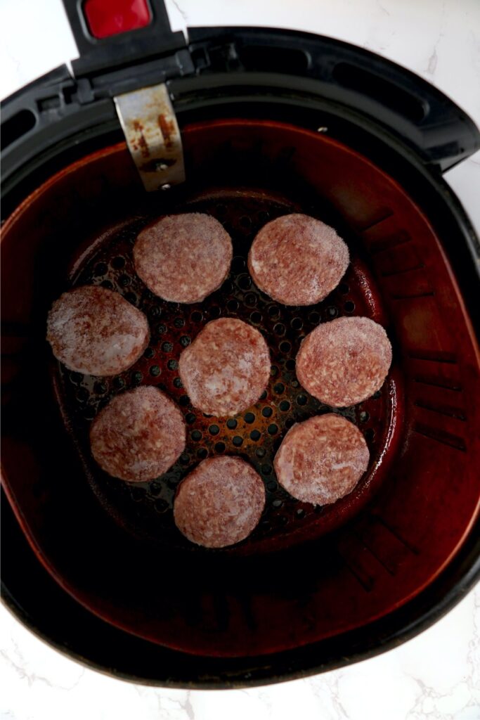 Overeheat shot of frozen sausage patties in air fryer basket