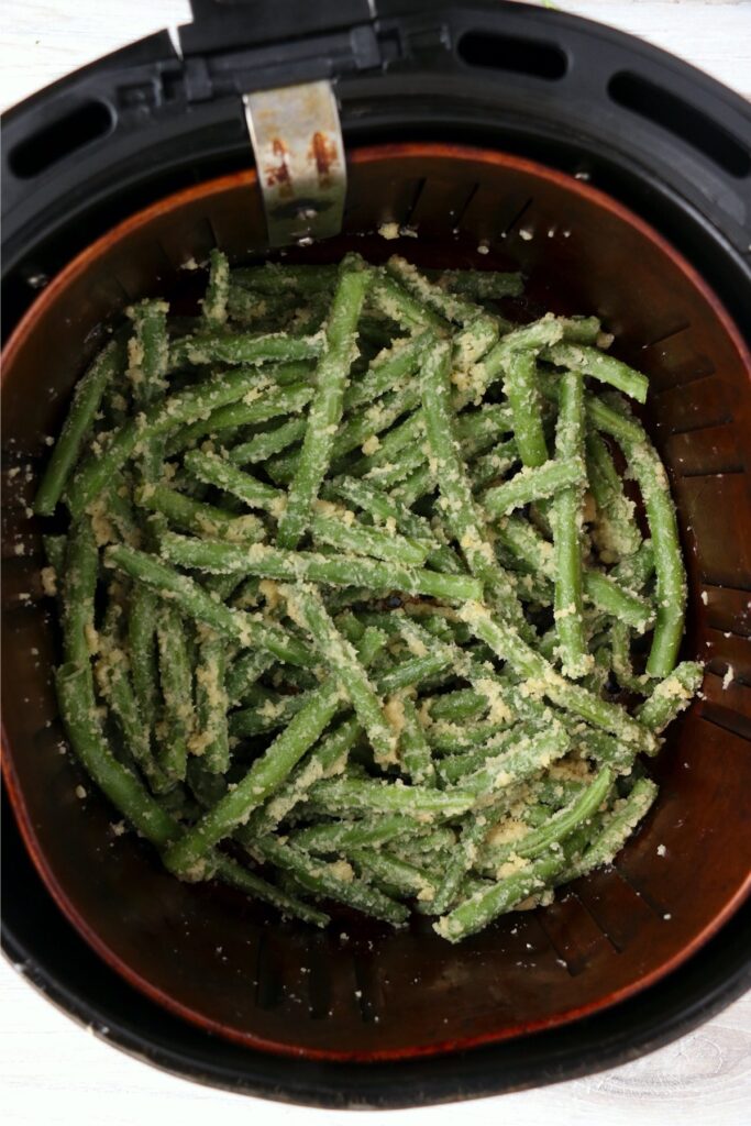 Overhead shot of green beans in air fryer basket