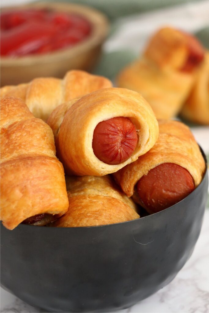 Closeup shot of bowlful of air fryer pigs in a blanket