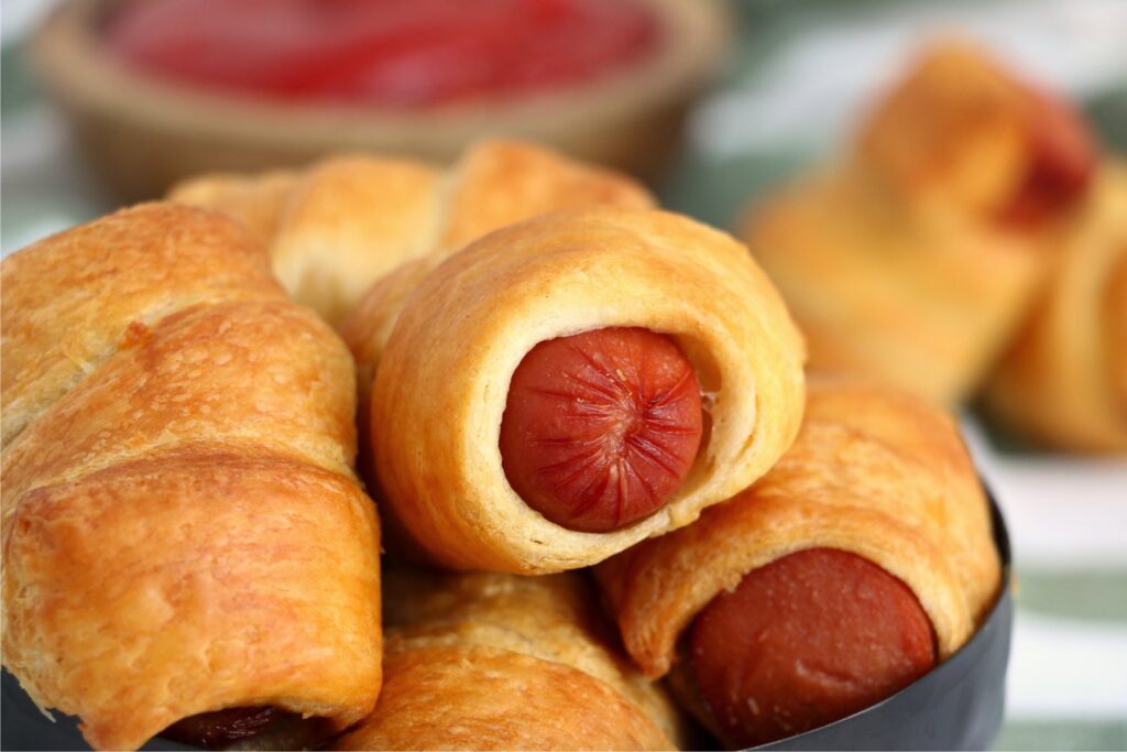 Closeup shot of bowlful of air fryer pigs in a blanket.