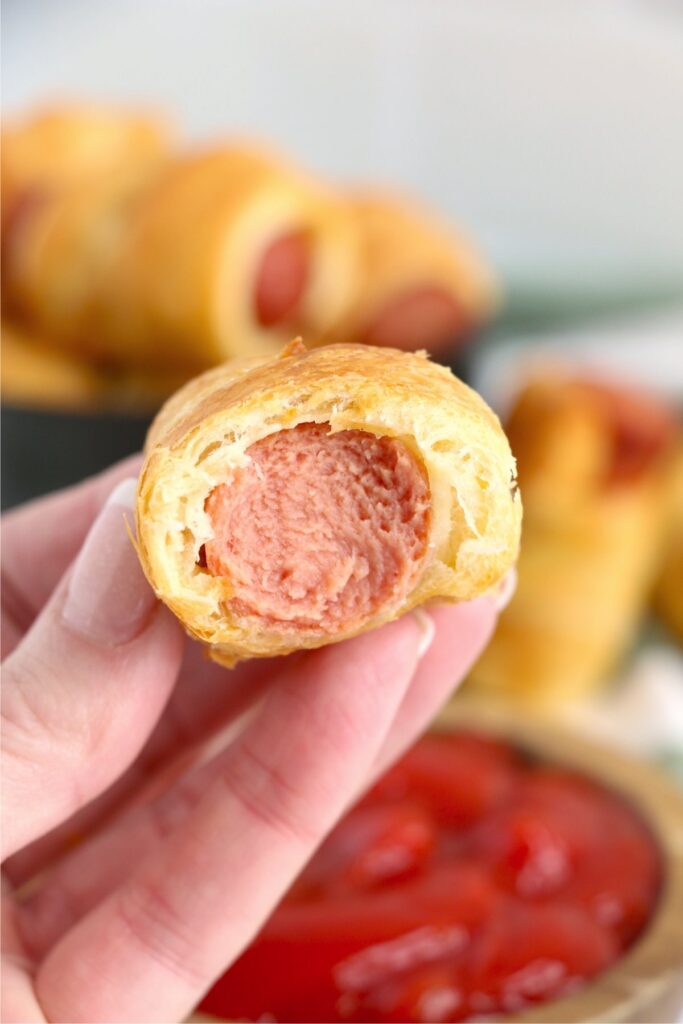 Closeup shot of air fryer pig in a blanket with bite taken out