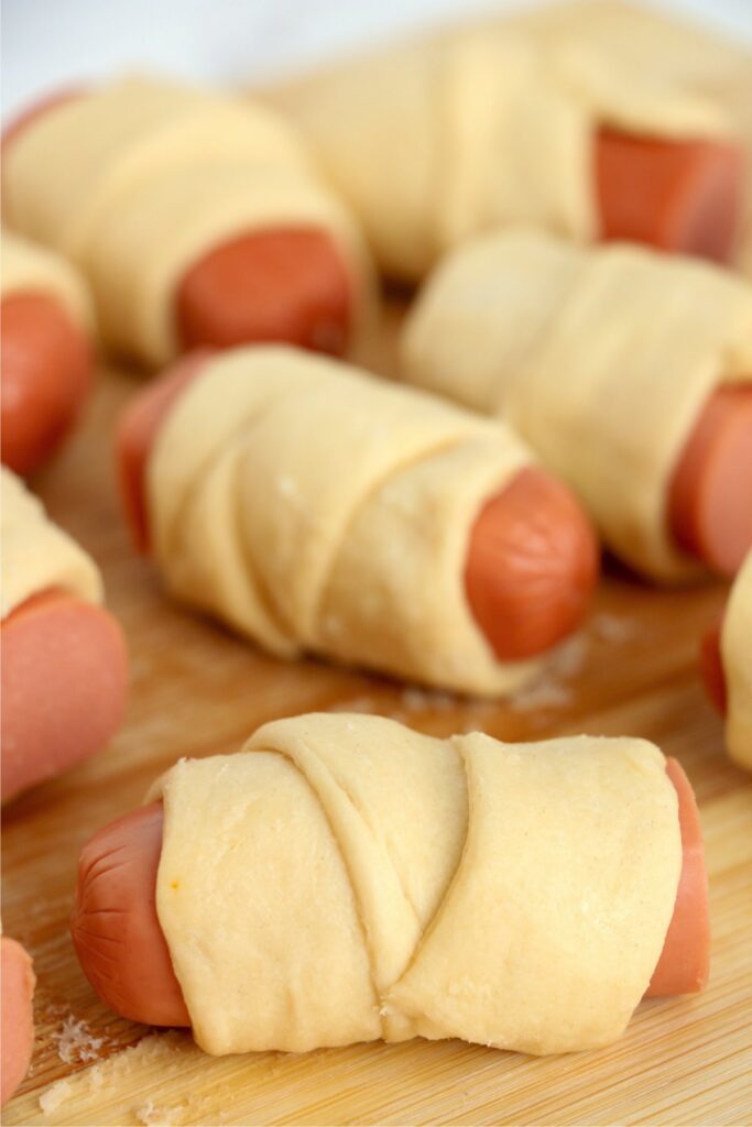 Closeup shot of pigs in a blanket on cutting board