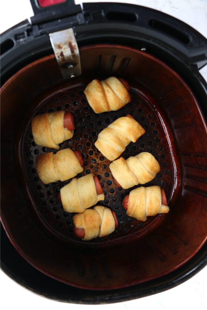 Overhead shot of air fryer pigs in a blanket in air fryer basket