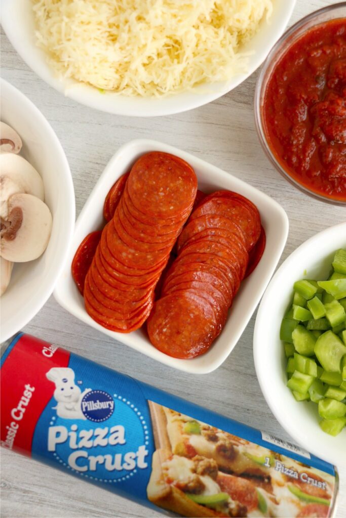 Overhead shot of pizza ingrdients in individual bowls