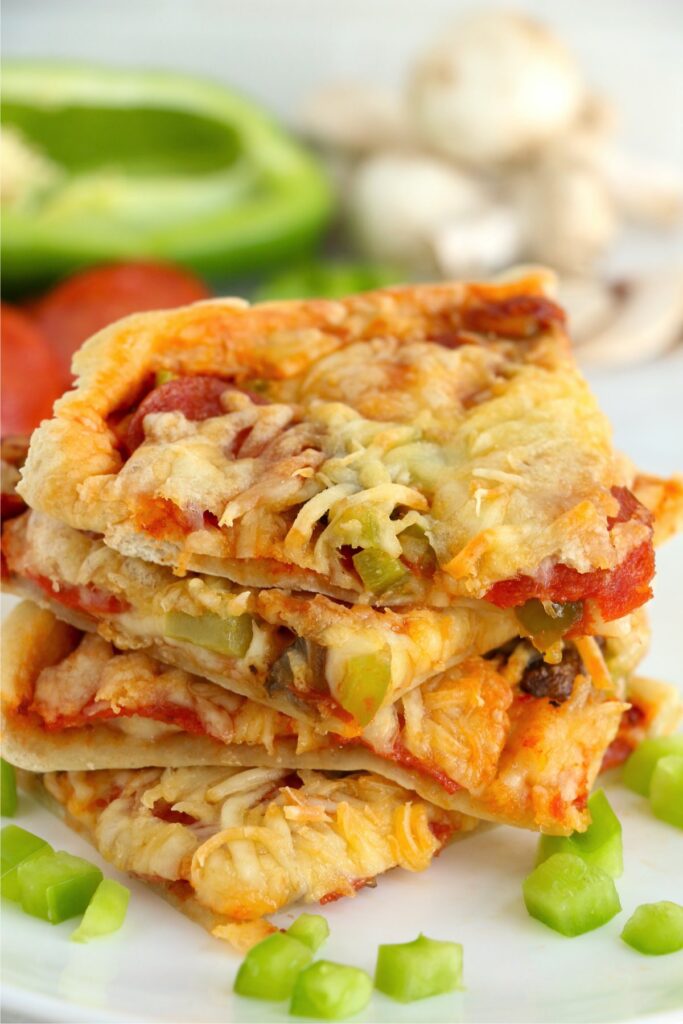 Closeup shot of slices of air fryer pizza stacked atop one another