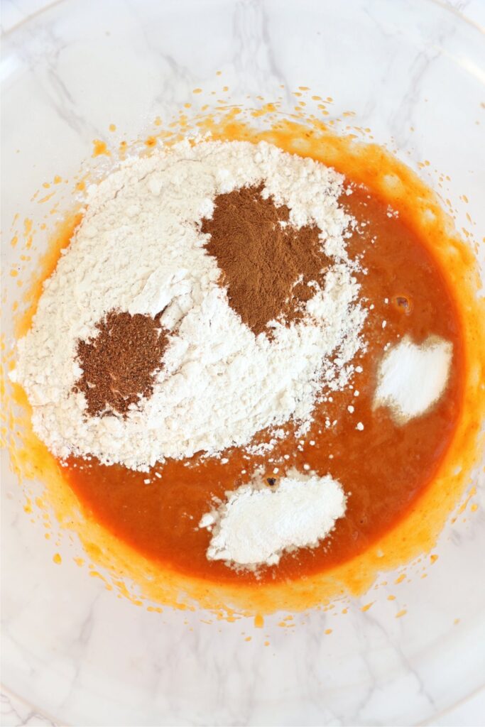 Overhead shot of flour and spices in bowl with wet ingredients