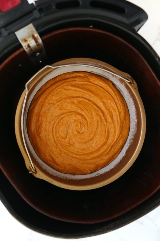 Overhead shot of pumpkin cake batter in air fryer.