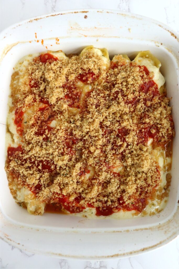 Overhead shot of bread cumbs topping the copycat Olive Garden stuffed shells in baking dish