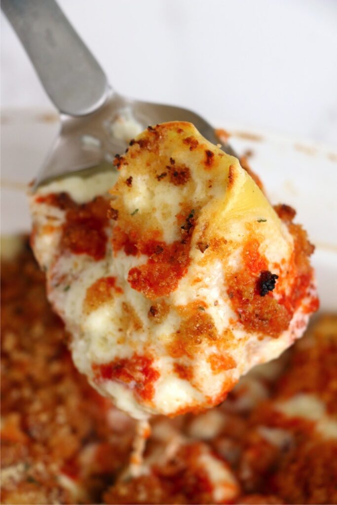 Overhead shot of copycat Olive Garden stuffed shells on spatula