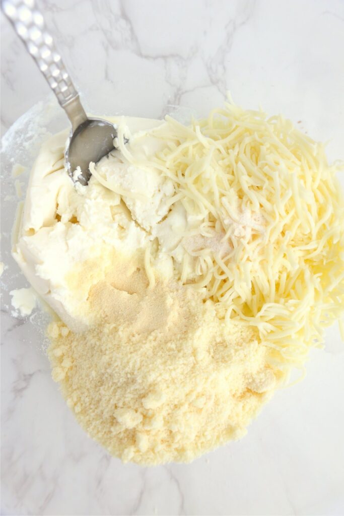 Closeup shot of cheeses in mixing bowl