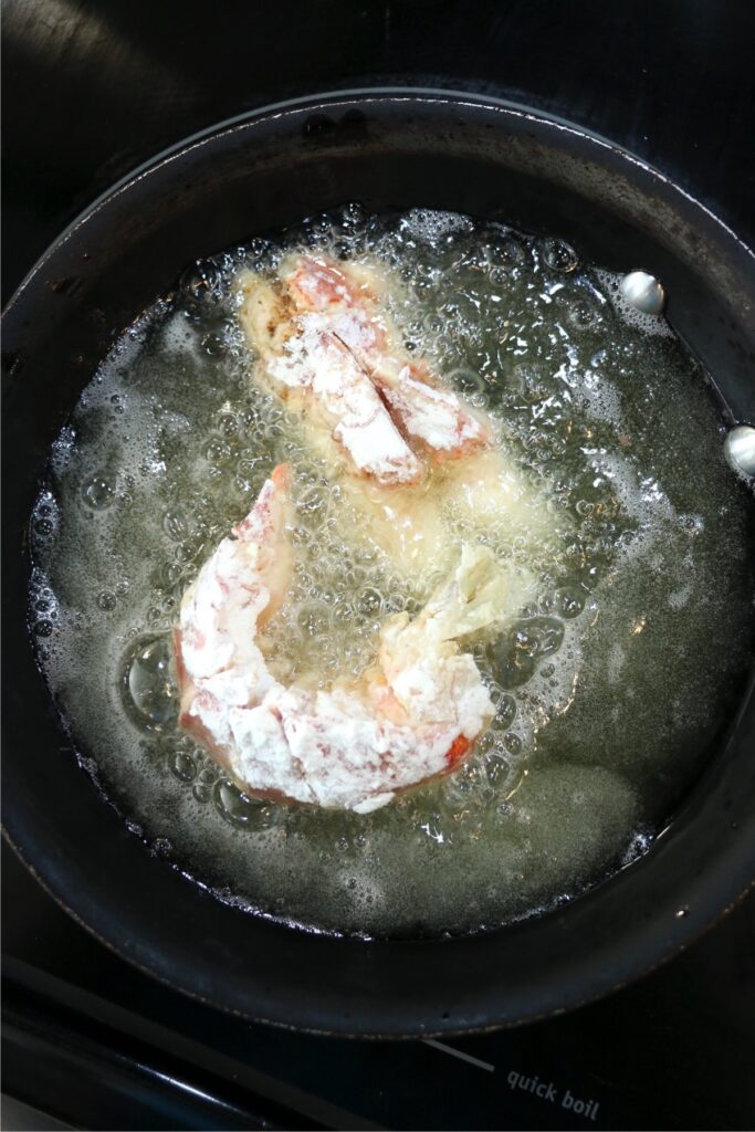 Overhead shot of lobster tails frying in pan