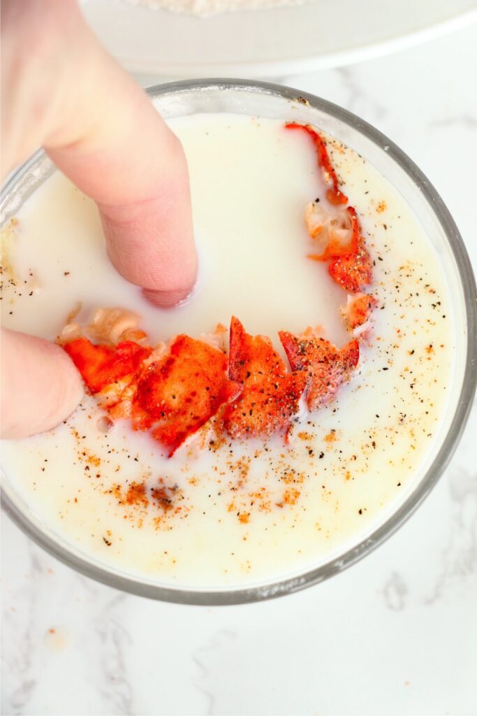 Lobster tail being dipped in milk