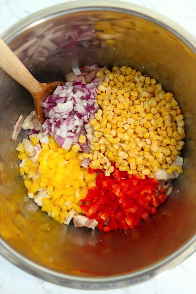 Overhead shot of corn and diced vegetables in instant pot