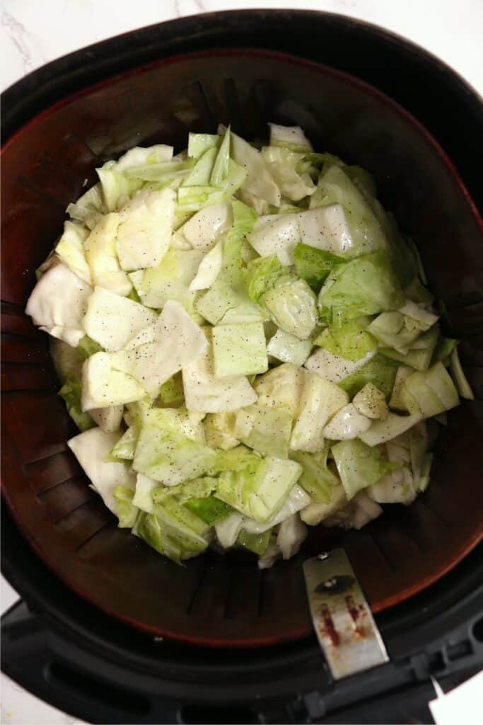 Overehead shot of seasoned cabbage in air fyer basket