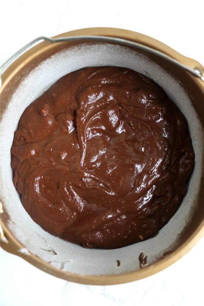 Overhead shot of brownie batter in air fryer cake pan