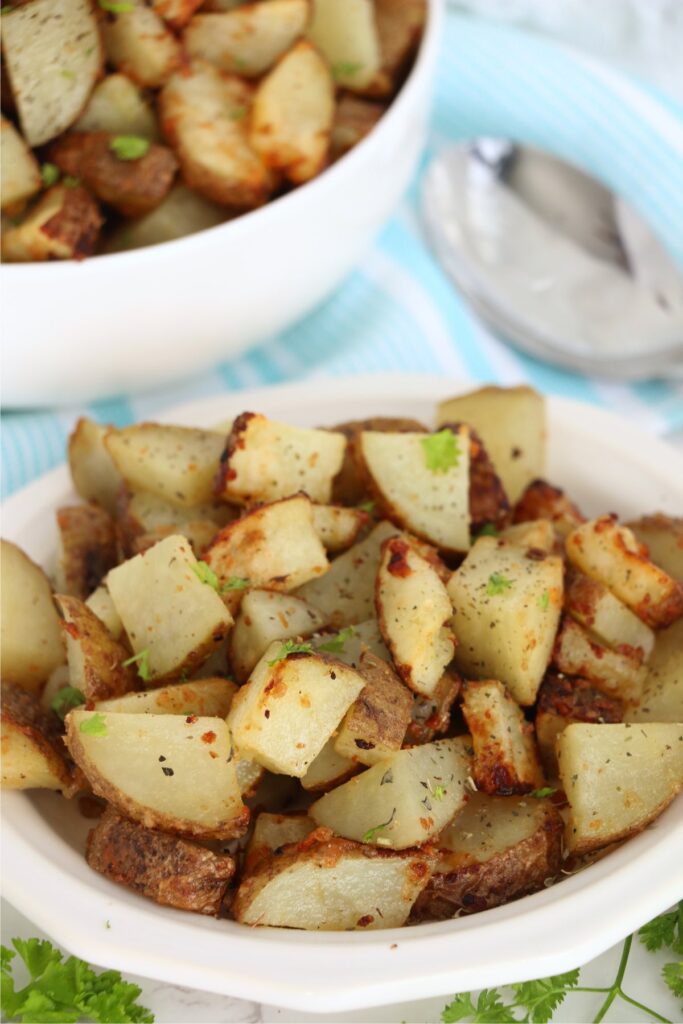 Closeup shot of bowlful of air fryer garlic parmesan potatoes