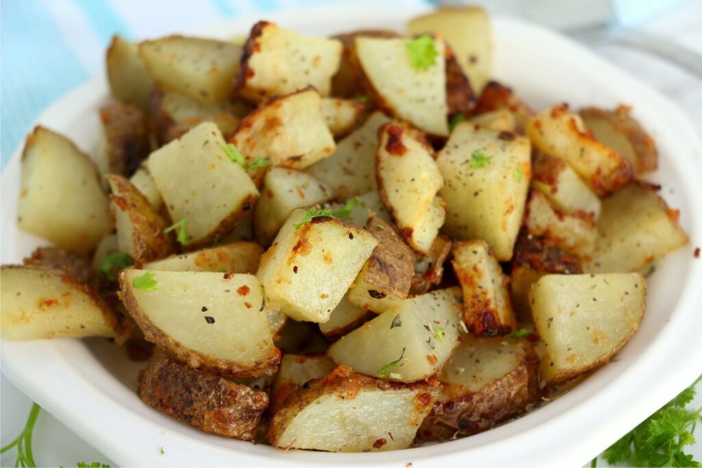 Closeup shot of air fryer garlic parmesan potatoes in bowl